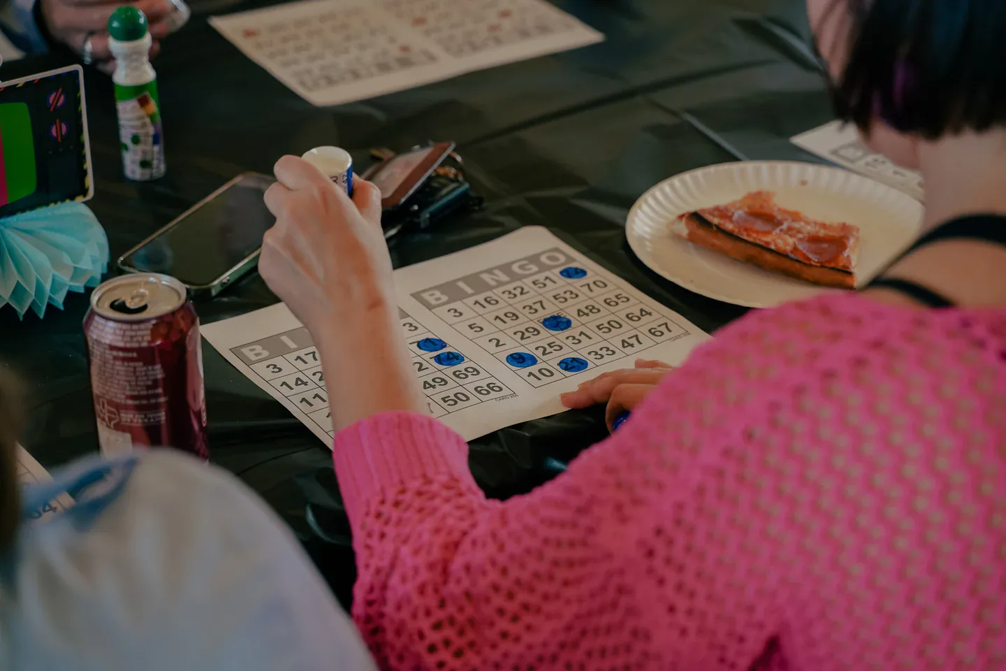 Neighbors enjoying Brooklyn Pizzeria slices during bingo