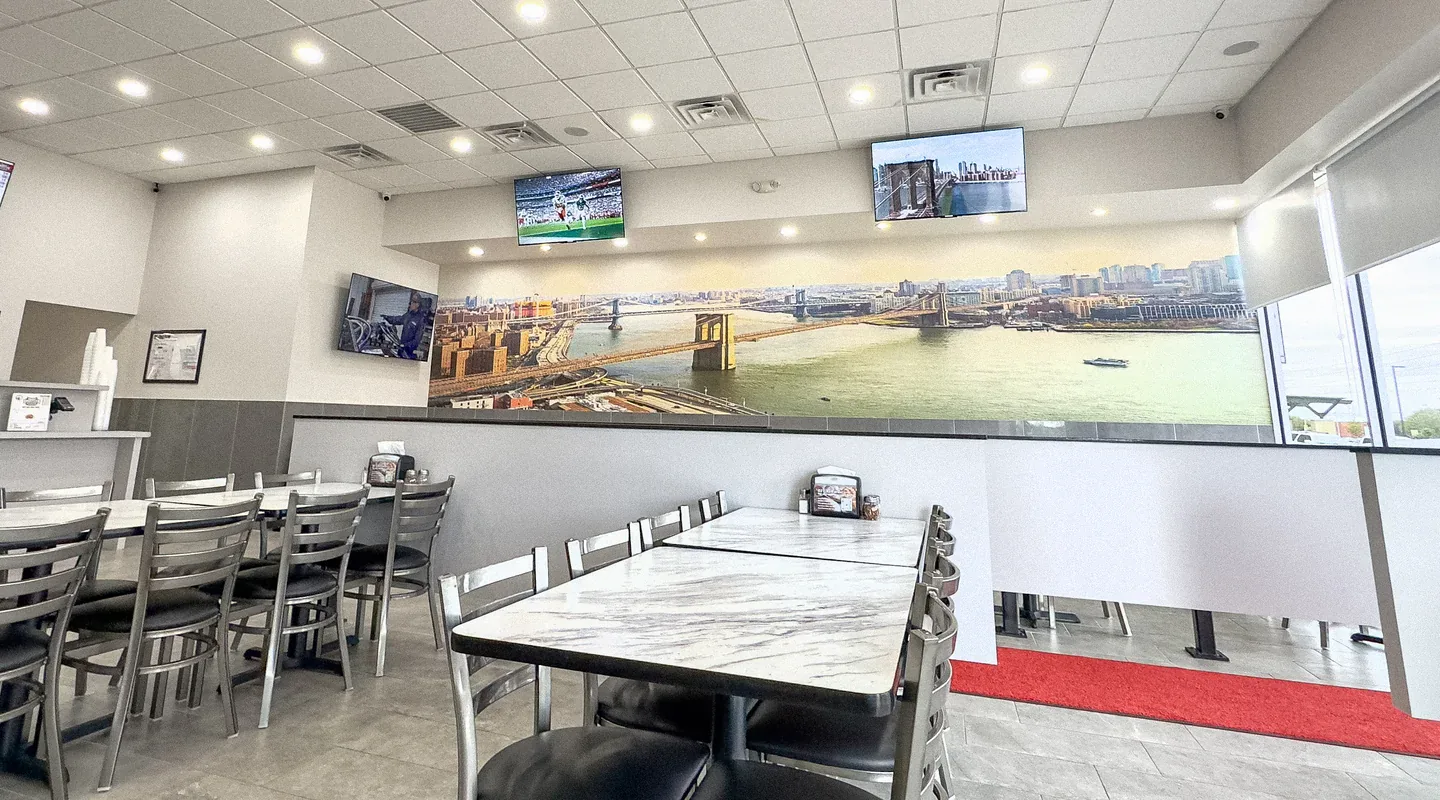 A welcoming Brooklyn Pizzeria dining room with a Brooklyn Bridge mural