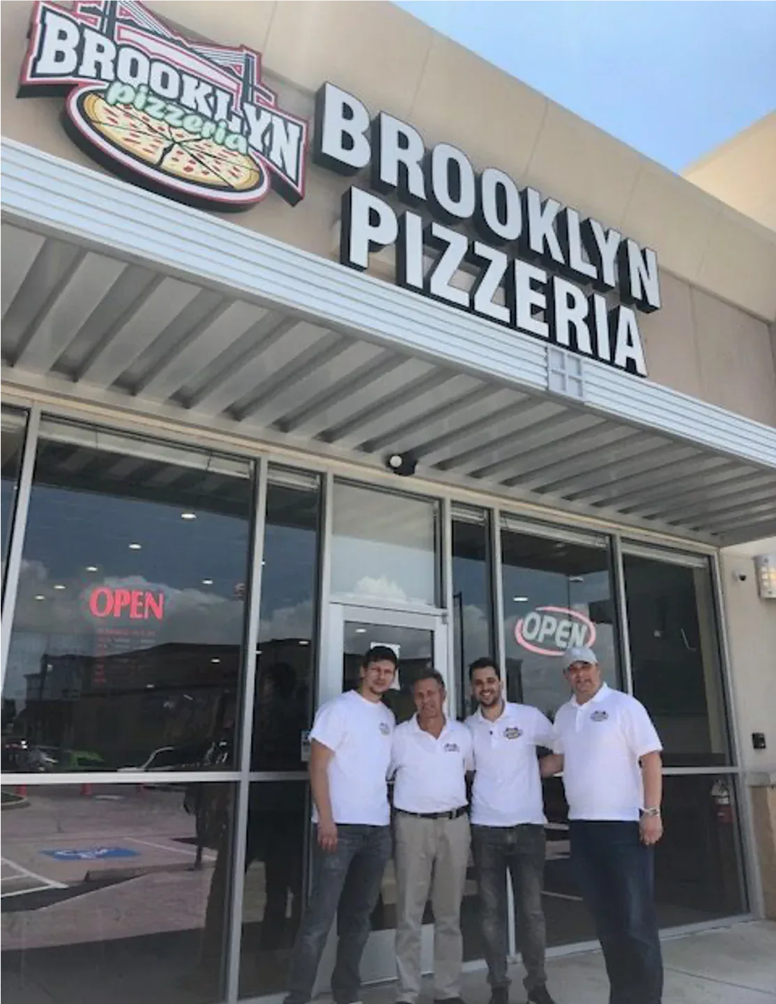 The Shahini family outside Brooklyn Pizzeria in Baytown, from the family album