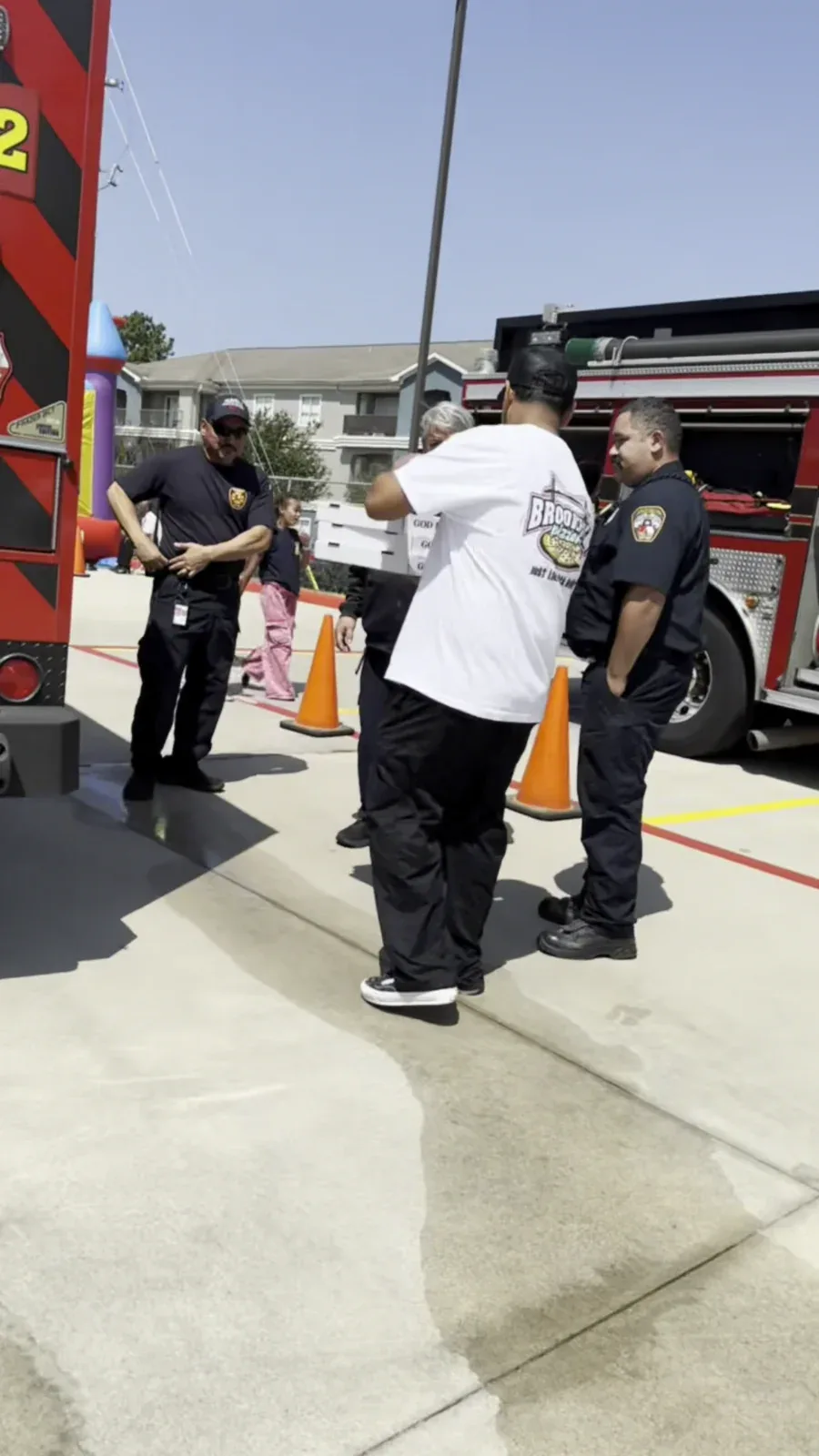 A Brooklyn Pizzeria team member sharing pizza with Atascocita firefighters