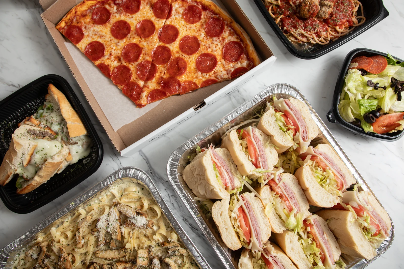 Brooklyn Pizzeria catering with pizza, pasta trays, sandwiches and individual meals