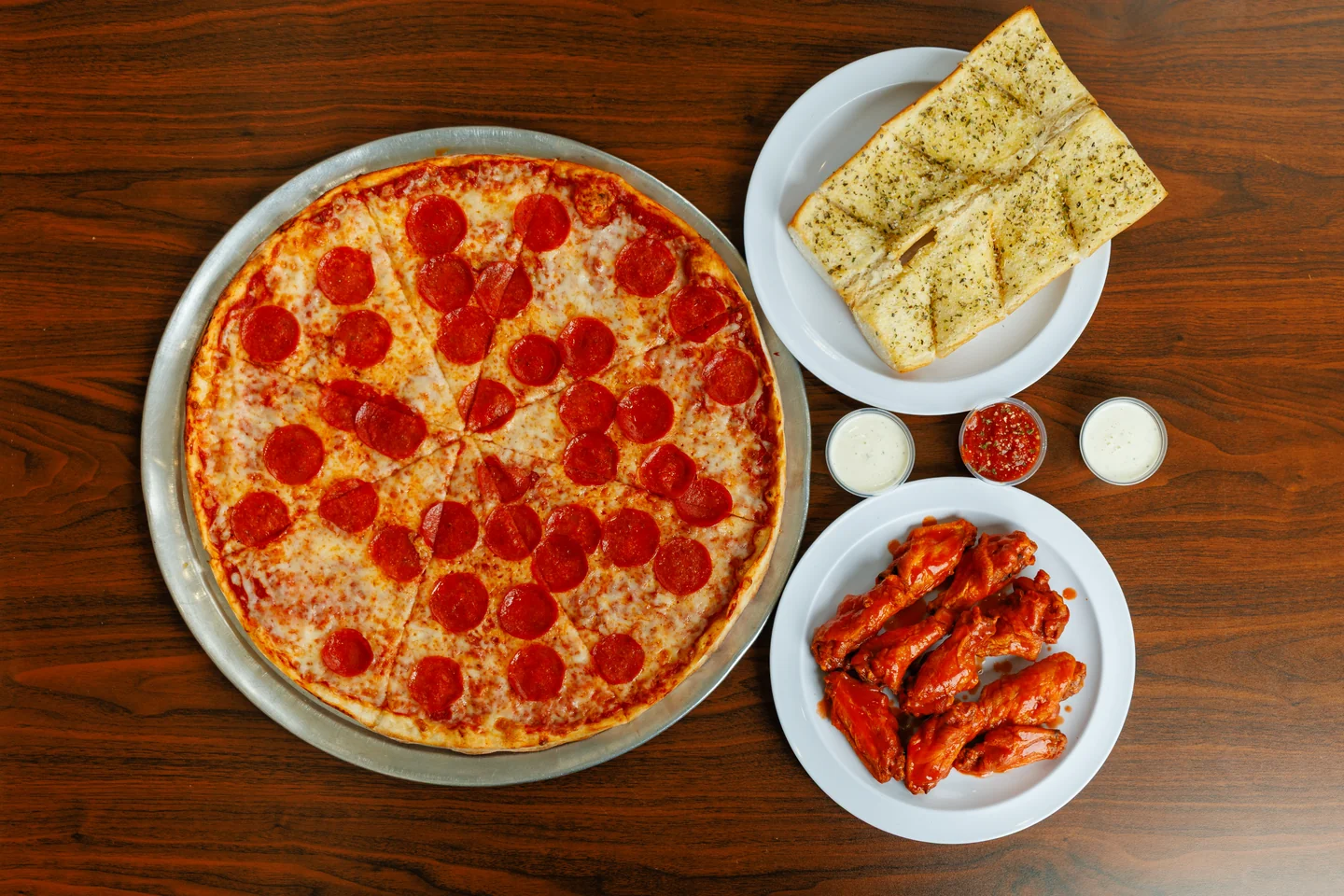 Brooklyn Pizzeria pepperoni pizza with wings and garlic bread