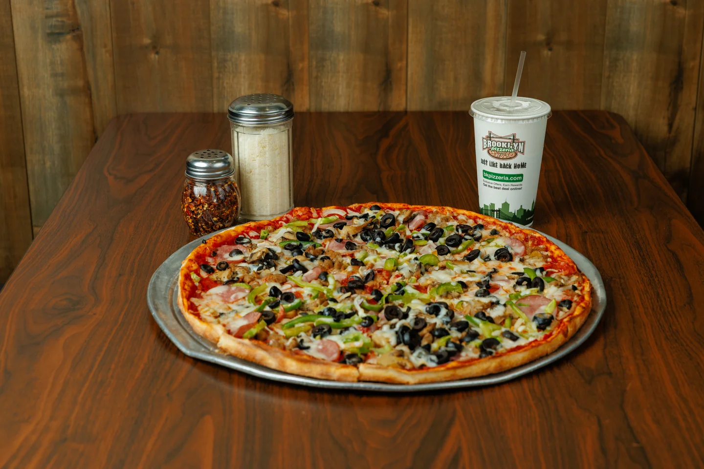 A Brooklyn Pizzeria specialty pizza with vegetables and other toppings